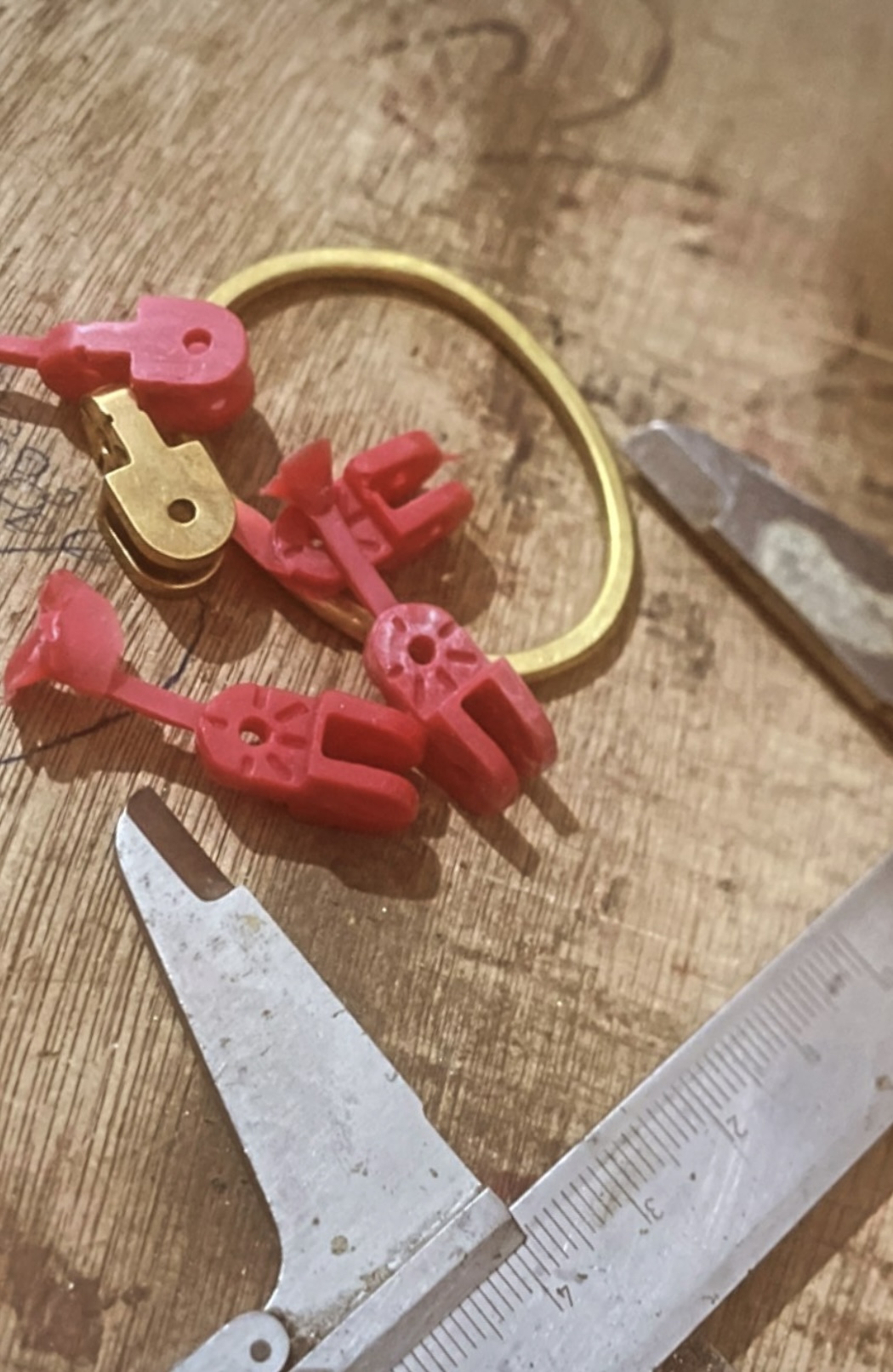 Red wax models and a gold ring on the jeweller's bench