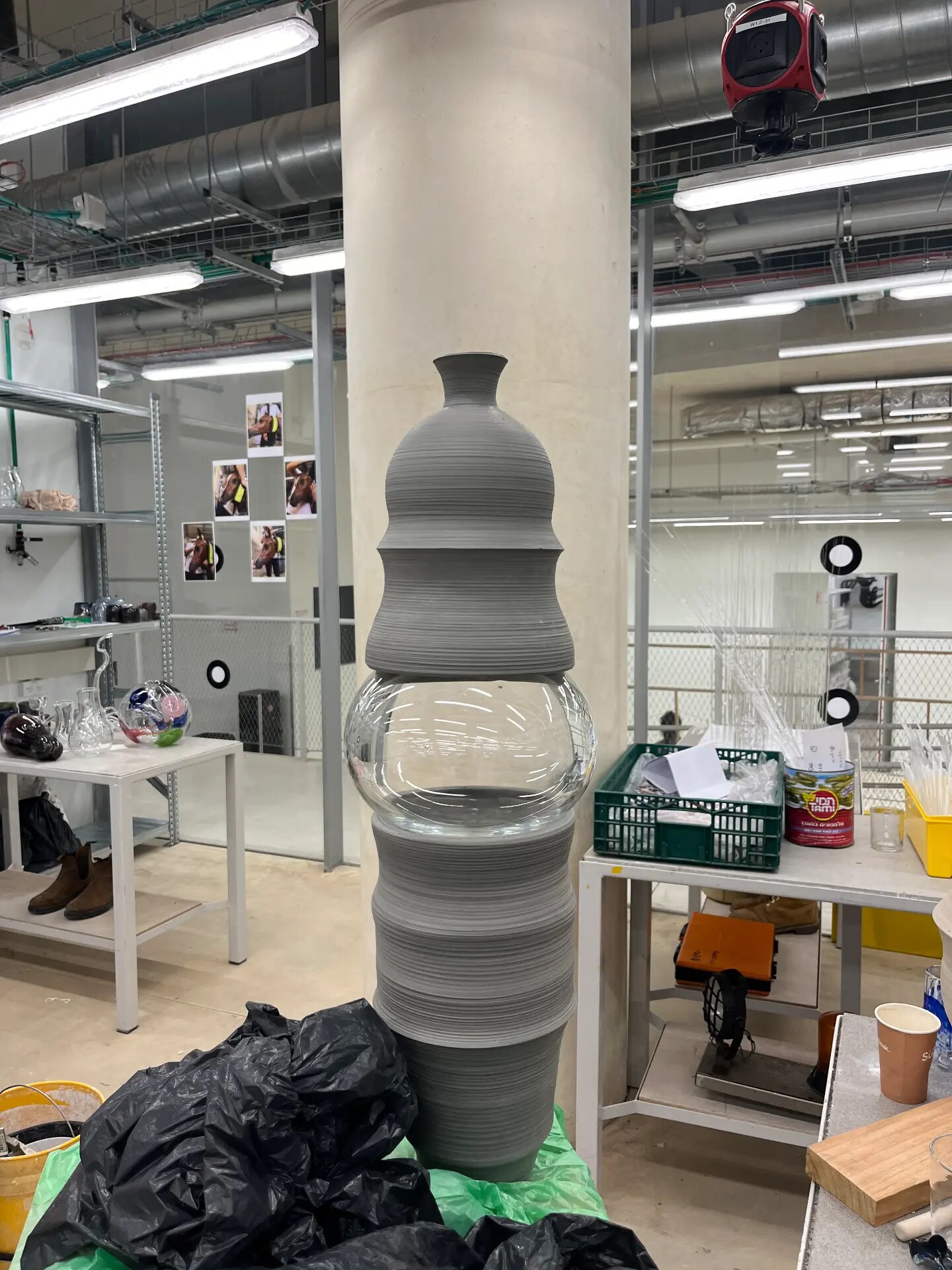 Stacked stoneware and glass elements in the studio