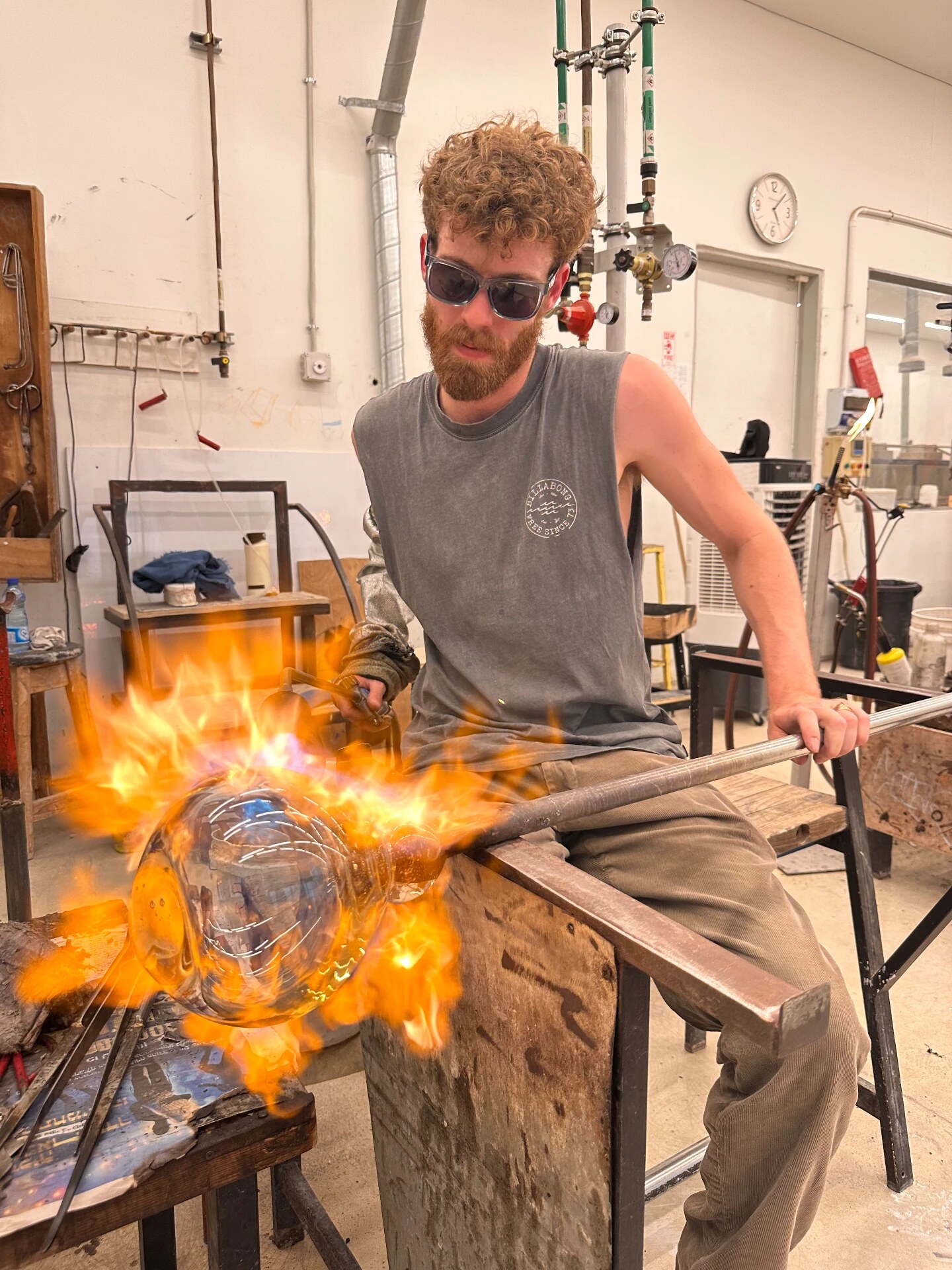 Shaping hot glass in the flame at the bench