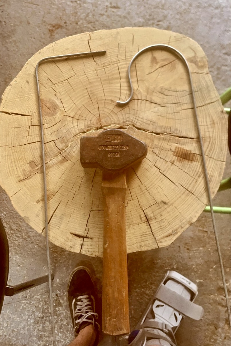 Hammer and bent steel rods on a wooden block